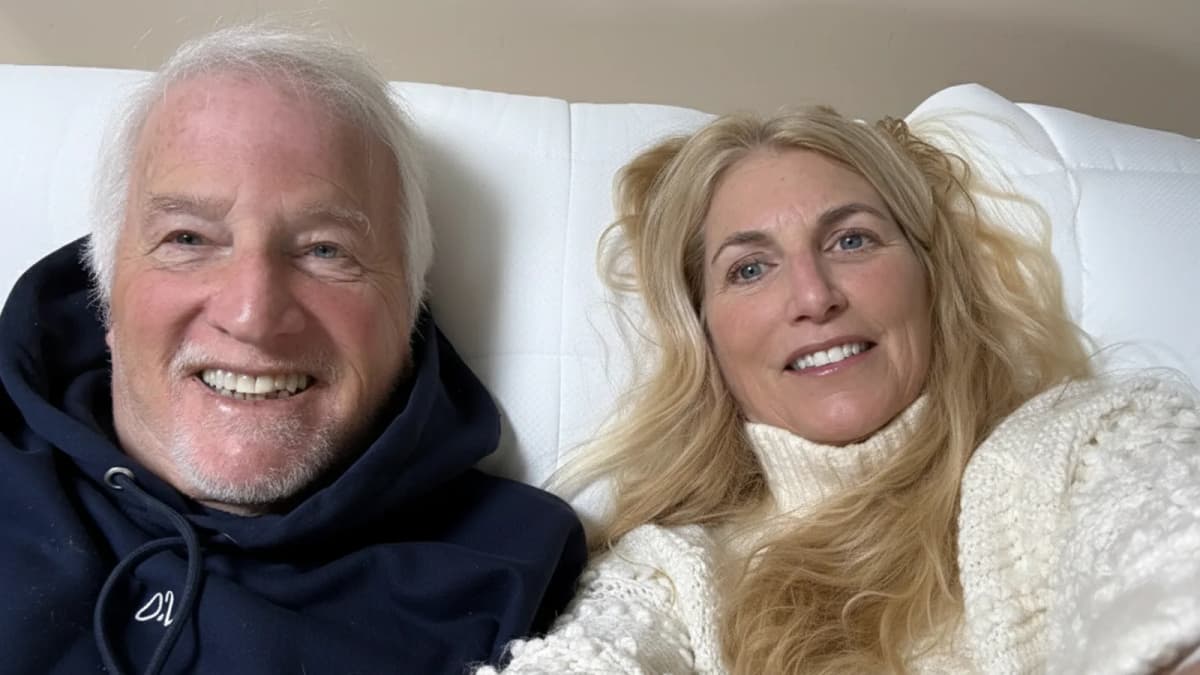 Happy couple on FluffCo pillow - man in black hoodie and woman in white